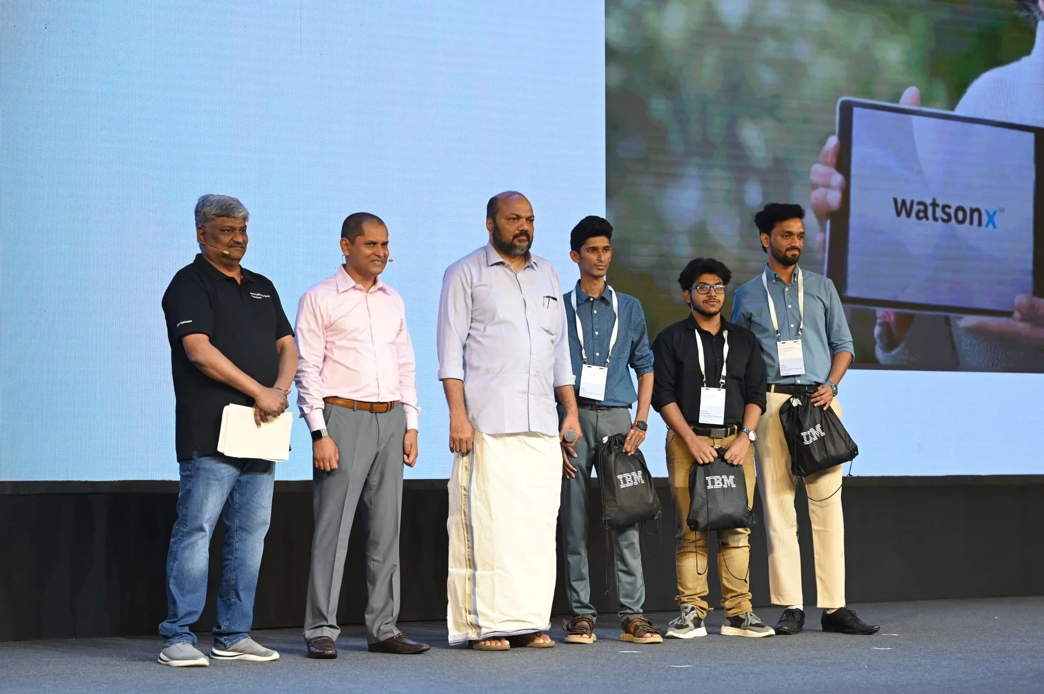 Robin Francis and team receiving recognition on stage at a watsonx event