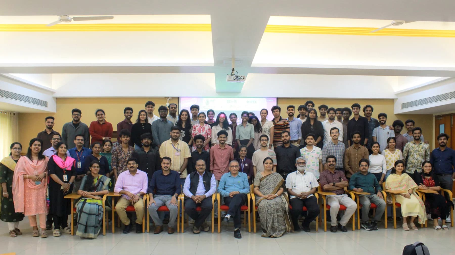 Large group photo with Robin Francis at an inclusive innovation program