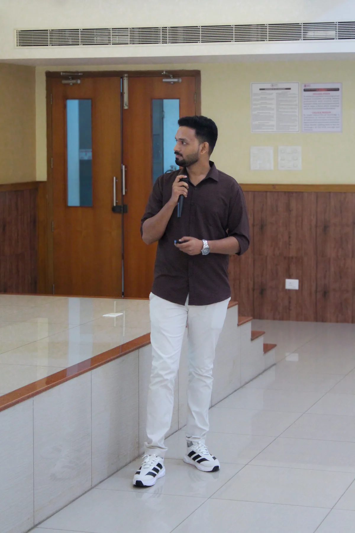 Robin Francis speaking with a microphone in a lecture hall