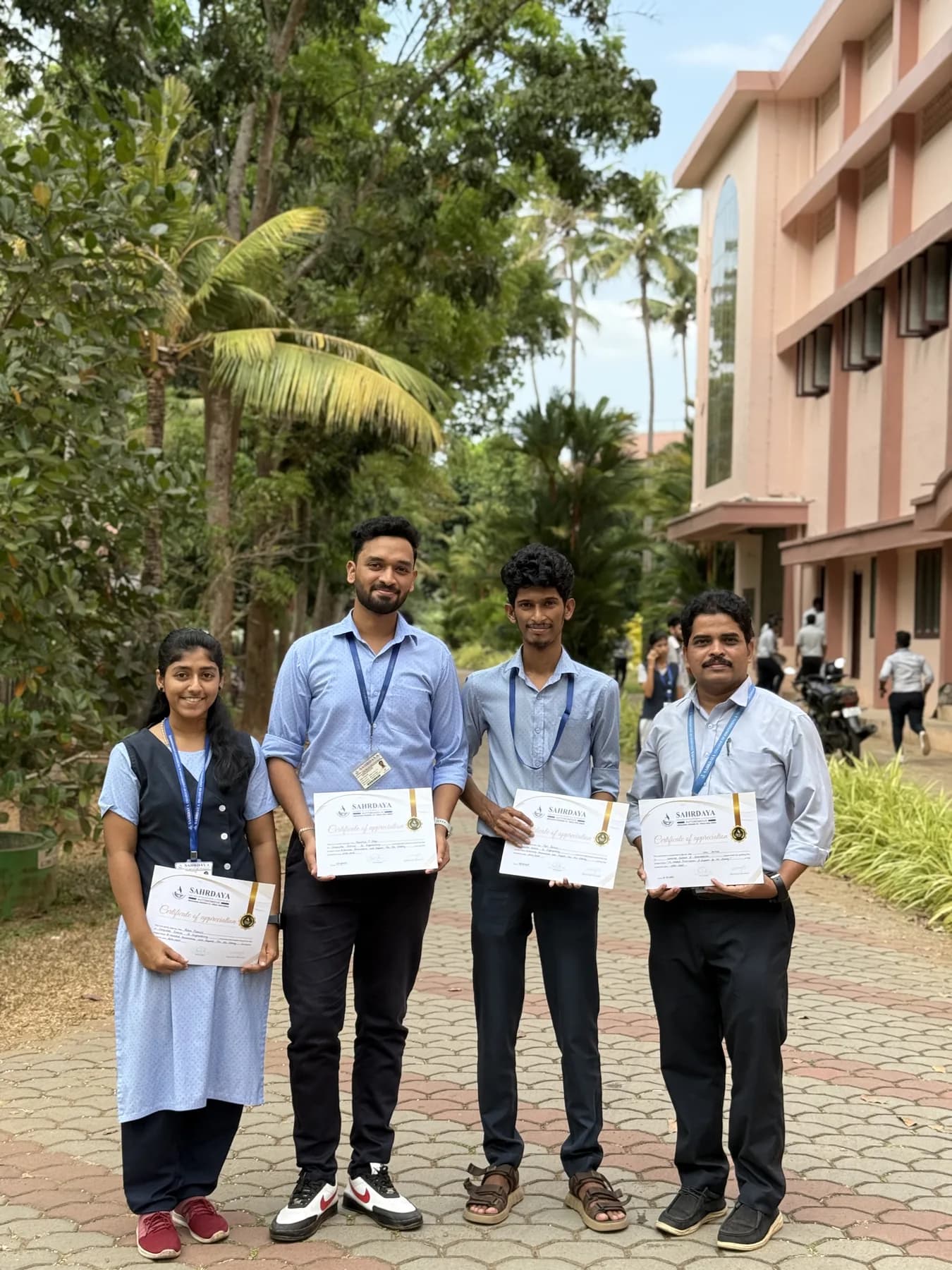 Students standing with certificates after a technology program