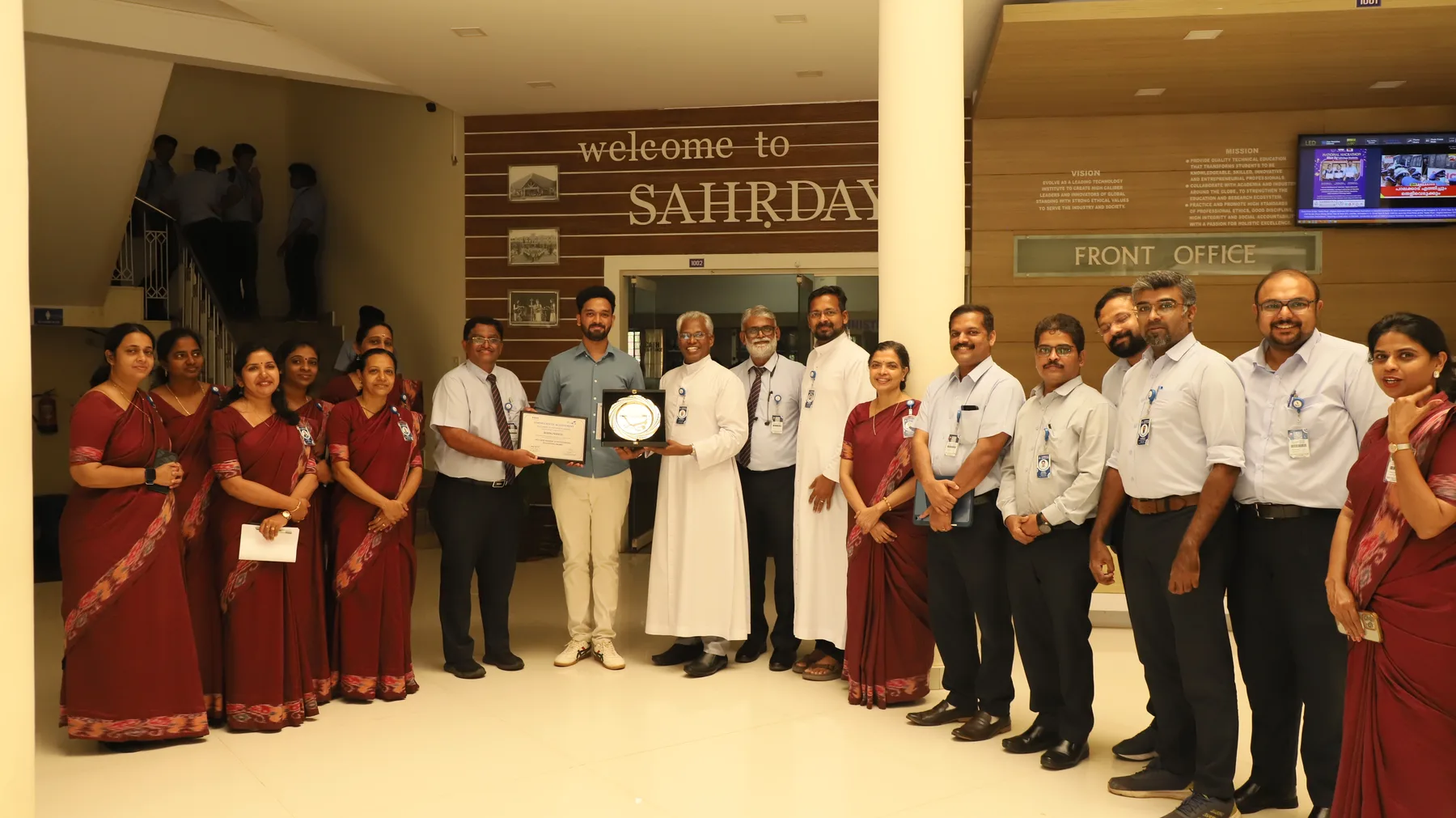 Robin Francis receiving recognition with Sahrdaya faculty and leaders