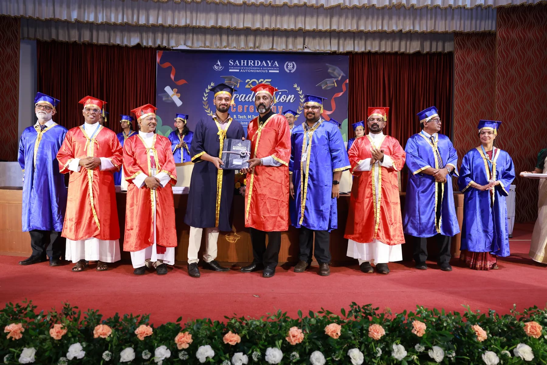 Robin Francis receiving an award on stage during Sahrdaya graduation