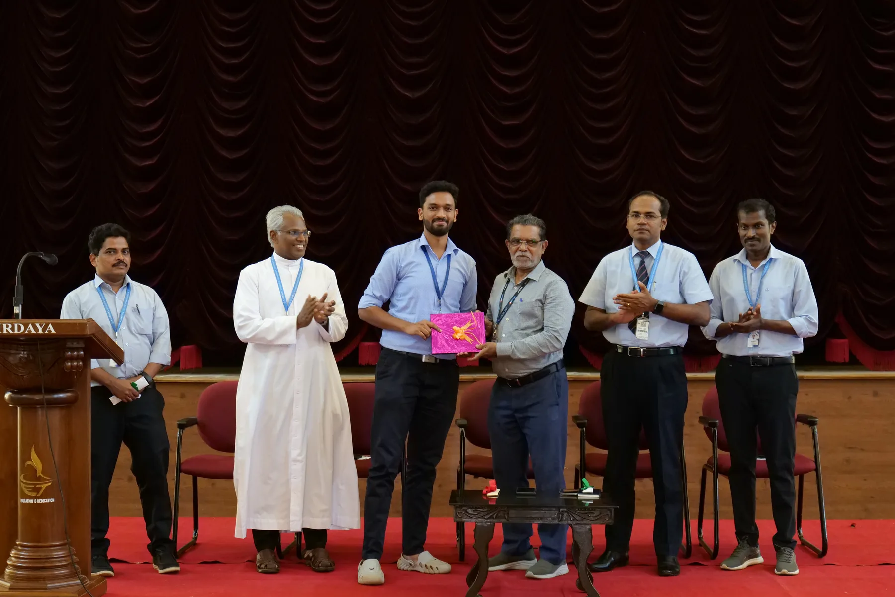 Robin Francis receiving appreciation on stage at Sahrdaya