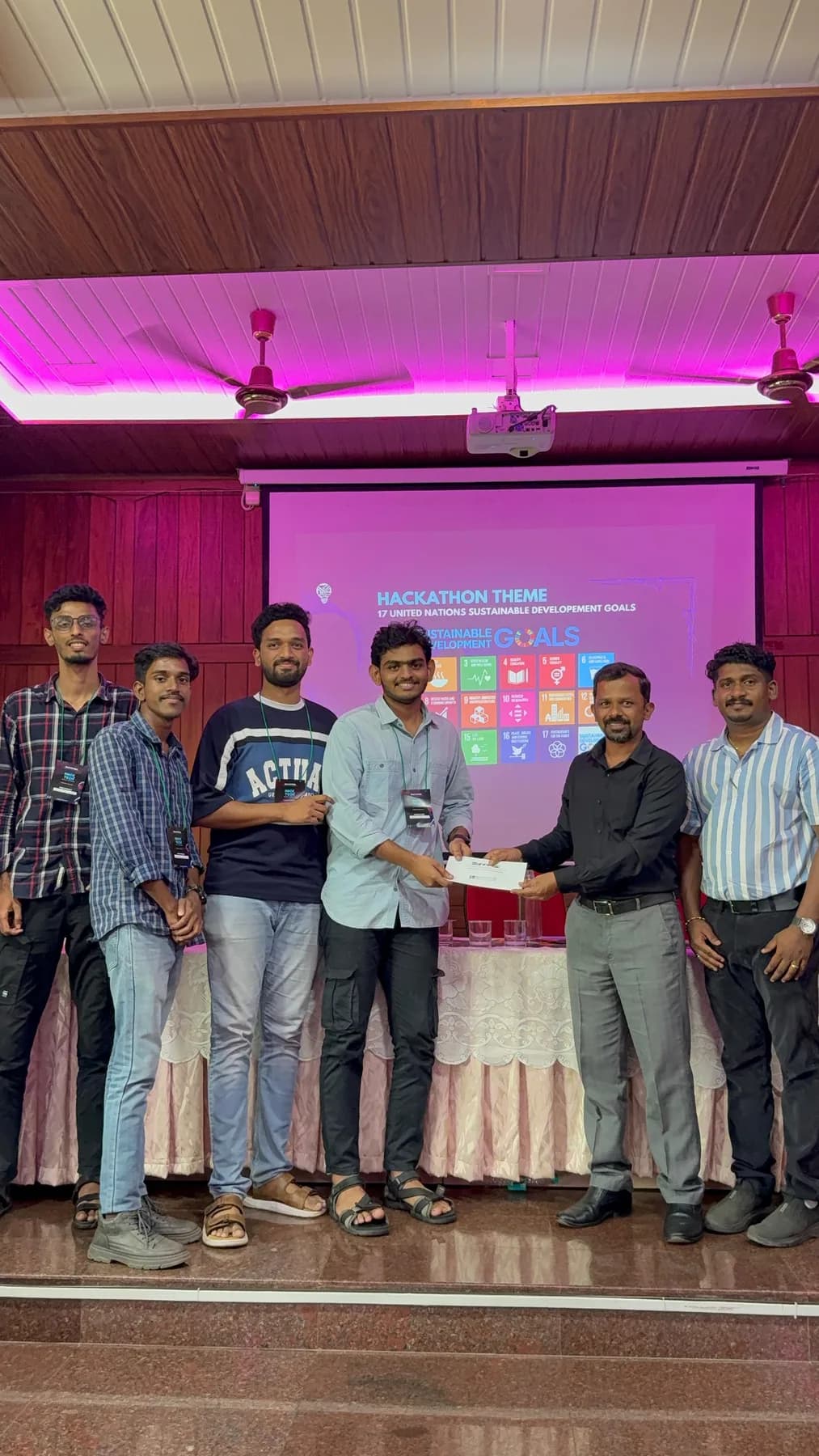 Robin Francis and teammates receiving recognition at a hackathon themed around the UN Sustainable Development Goals