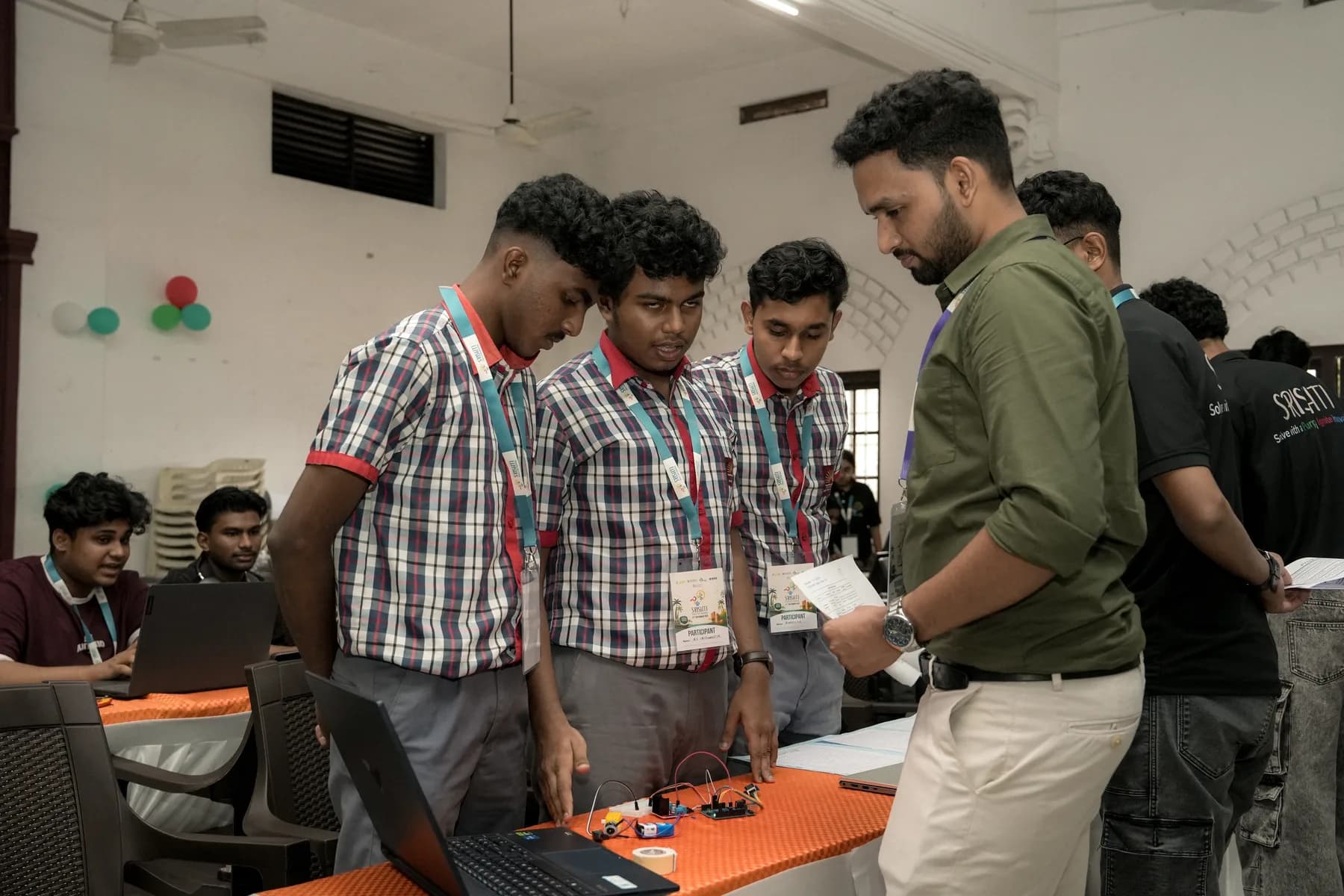 Robin Francis reviewing a student prototype during a technology workshop
