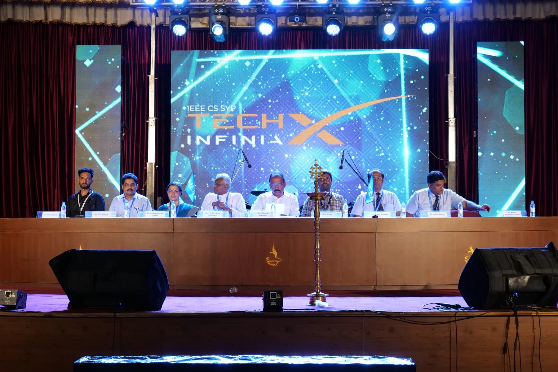 Opening panel on stage at TechX Infinia with Robin Francis seated at the table