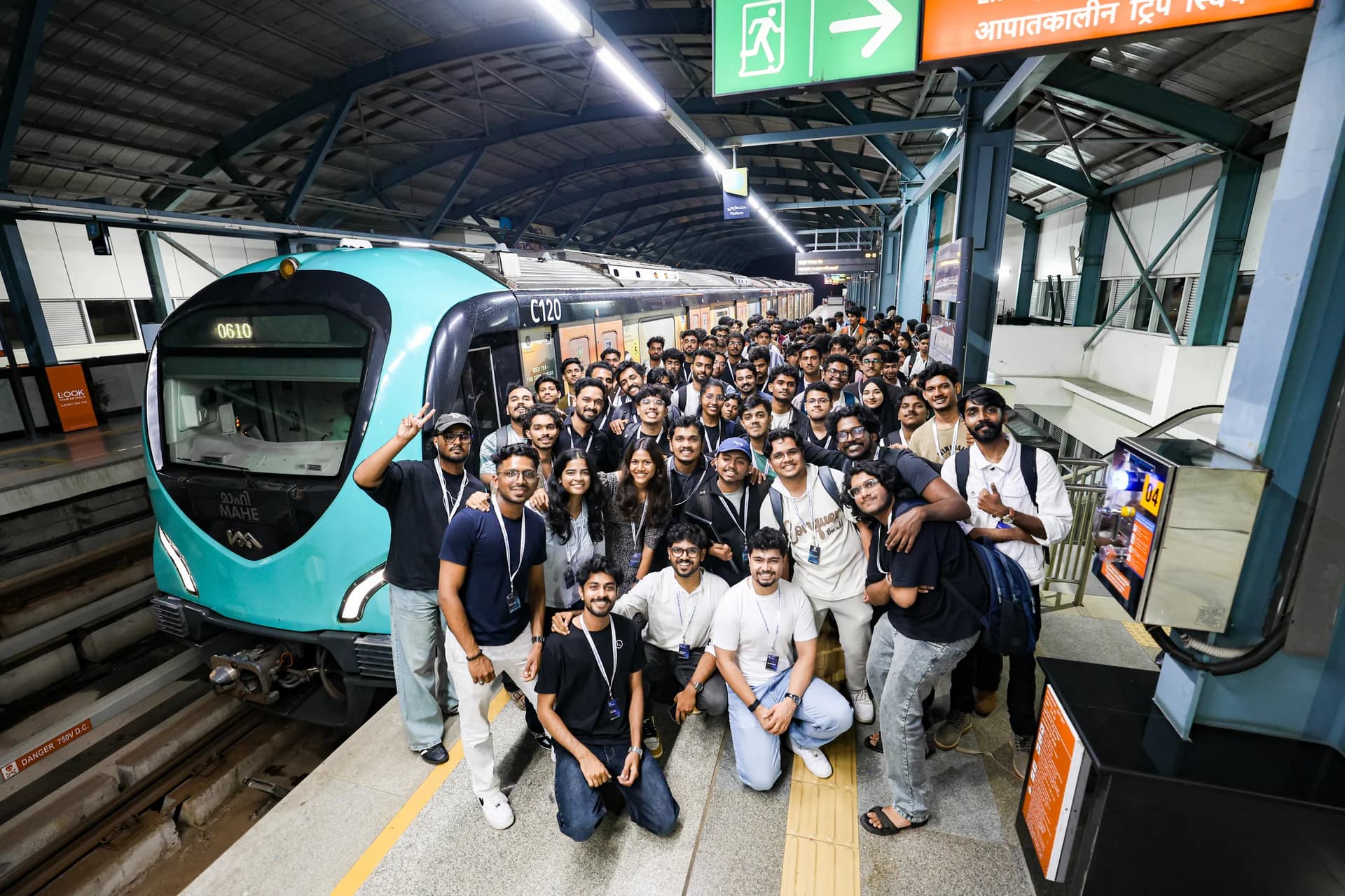 Codex Nightline builders gathered on the Kochi Metro platform beside the after-hours train