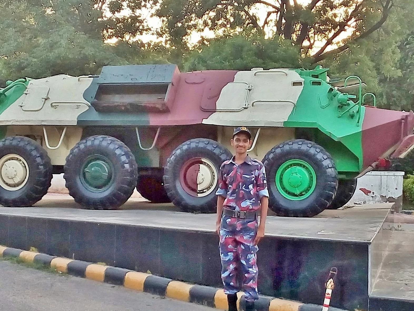 Robin Francis standing in front of an armoured personnel carrier at the national camp
