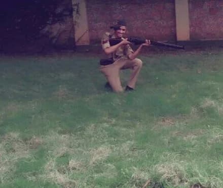 Robin Francis in the kneeling firing position with a .22 rifle during NCC training