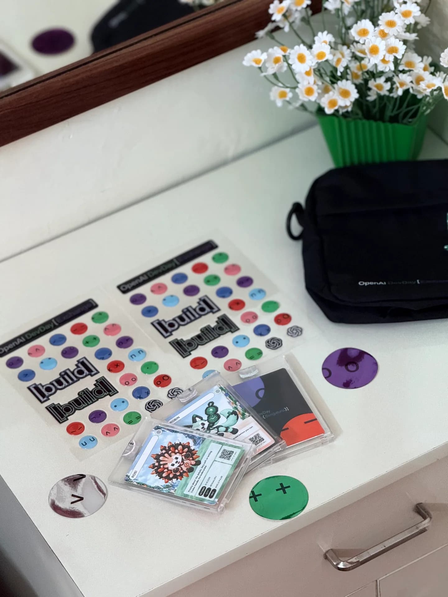 Builder stickers and event mementos collected by Robin Francis at OpenAI DevDay Exchange Bengaluru