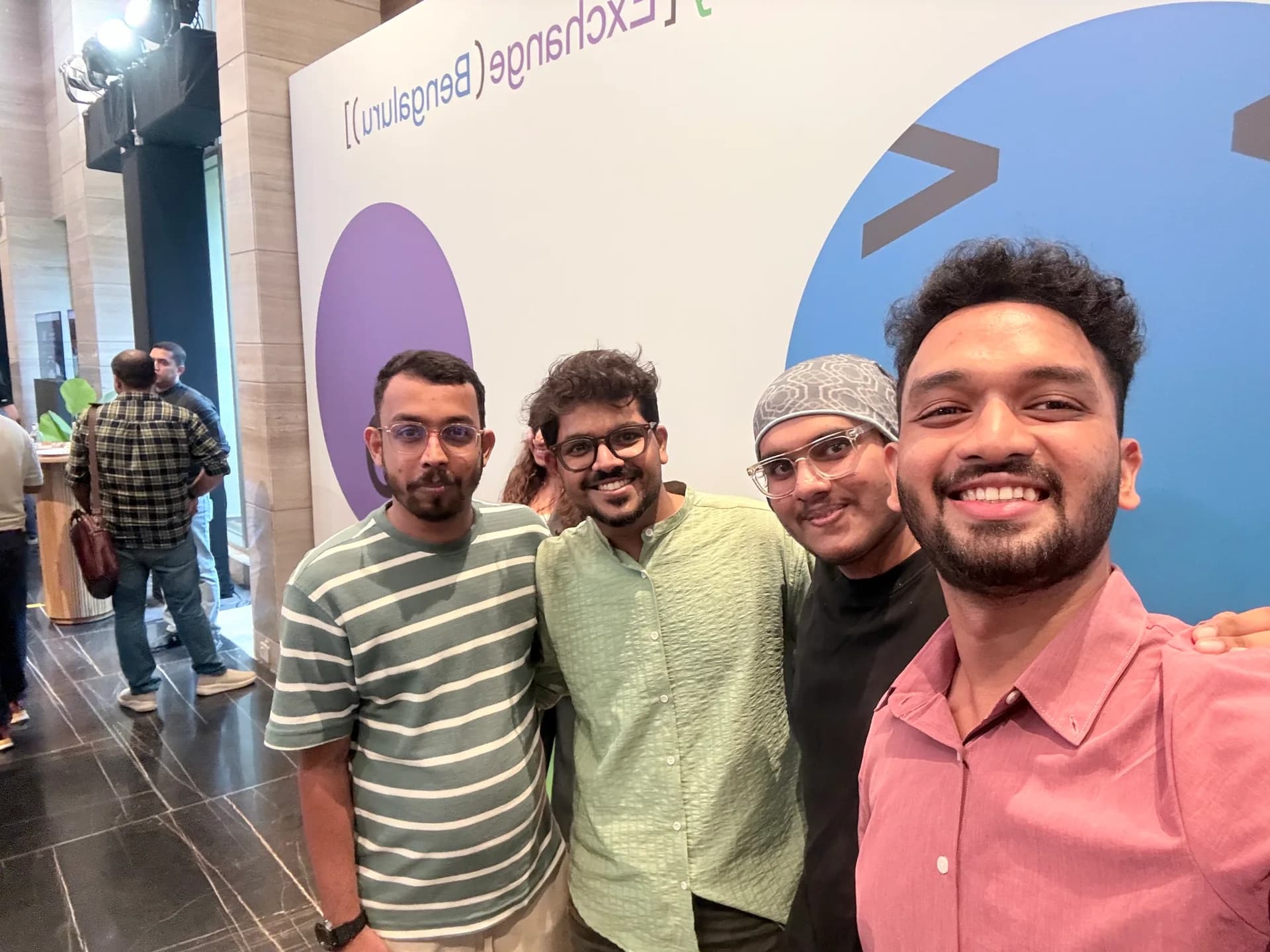 Robin Francis and fellow builders posing together beside the OpenAI DevDay Exchange Bengaluru backdrop